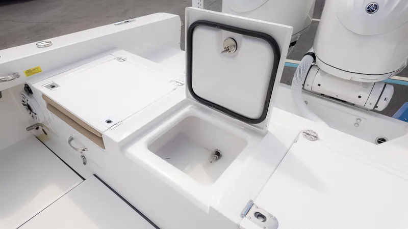 Slide: The Image of Open storage compartment on 2025 Everglades 273CC boat deck. - 15
