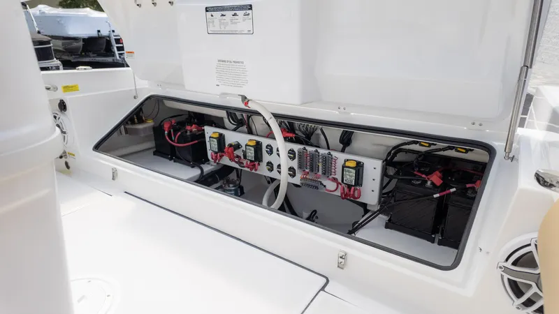 Slide: The Image of 2025 Everglades 273CC boat electrical compartment with batteries and wiring. - 17