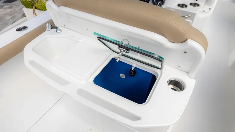 Slide: The Image of 2025 Everglades 273CC boat interior with sink and storage compartments. - 18