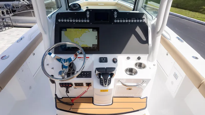 Slide: The Image of 2025 Everglades 273CC boat dashboard with steering wheel and navigation display. - 20