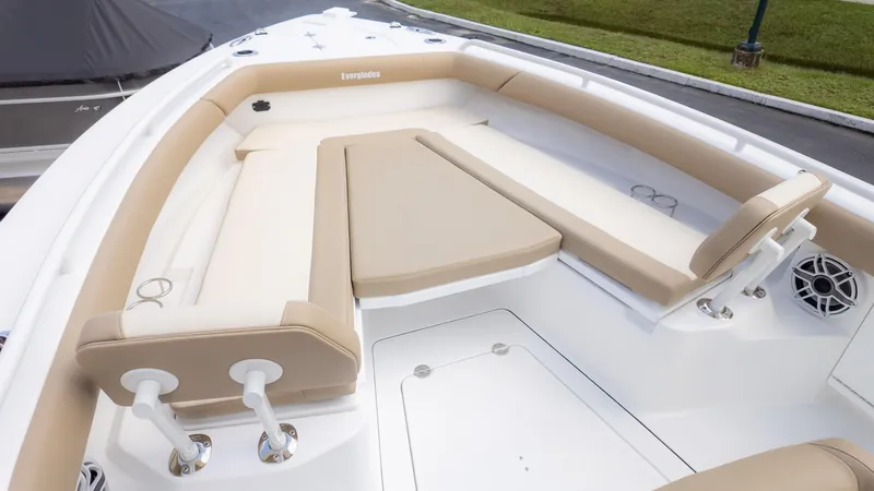 Slide: The Image of 2025 Everglades 273CC boat interior with beige seating and cup holders. - 24