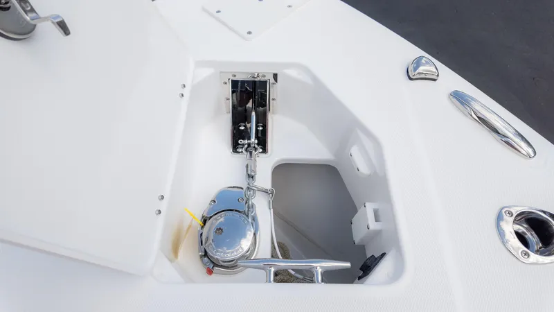 Slide: The Image of Anchor compartment of 2025 Everglades 273CC boat, featuring a polished winch system. - 27