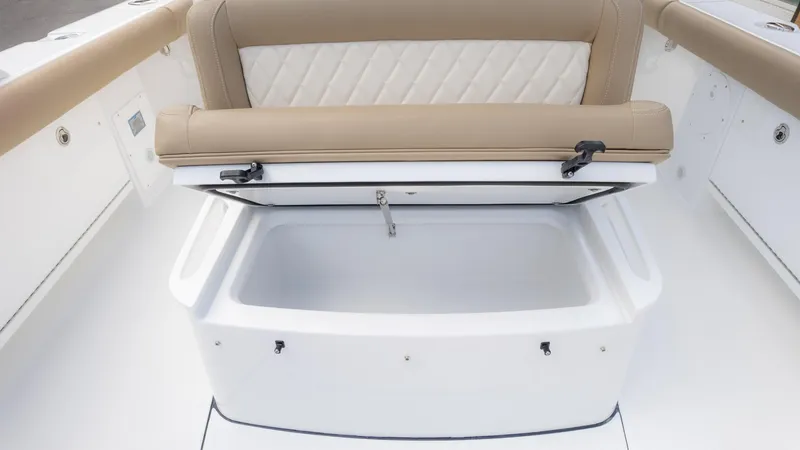 Slide: The Image of 2025 Everglades 273CC boat with open storage compartment and cushioned seating. - 28