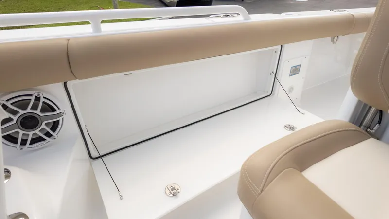 Slide: The Image of 2025 Everglades 273CC boat interior with beige seating and speaker system. - 30