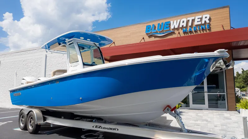 Slide: The Image of 2025 Everglades 273CC boat on trailer at Bluewater Marine dealership. - 4
