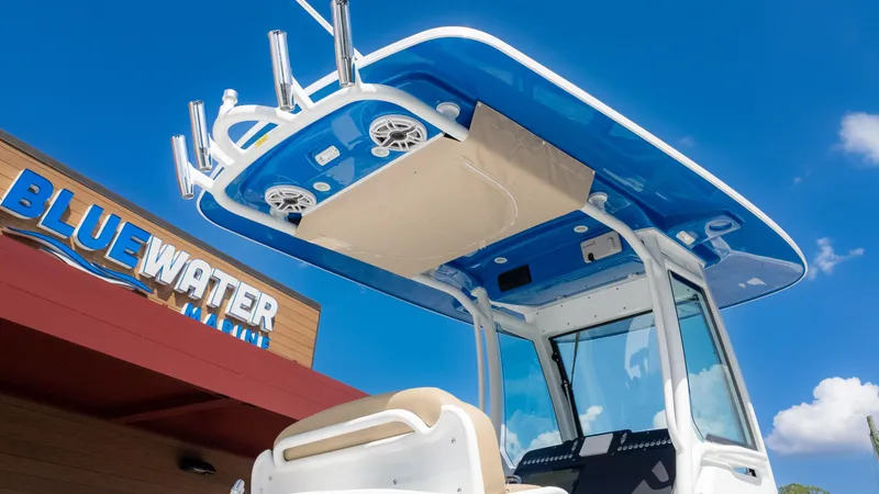 Slide: The Image of 2025 Everglades 273CC boat at Bluewater Marine, featuring a sleek blue and white design. - 9