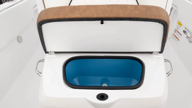 Slide: The Image of Open storage compartment on 2025 Stingray 173CC boat with blue interior. - 11