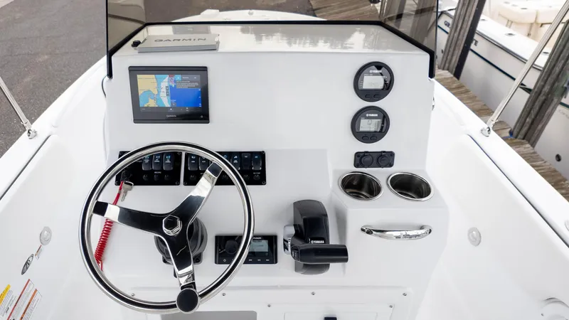 Slide: The Image of 2025 Stingray 173CC boat dashboard with Garmin navigation, steering wheel, and Yamaha controls. - 14