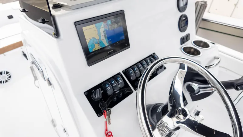 Slide: The Image of 2025 Stingray 173CC boat dashboard with steering wheel, navigation screen, and control panel. - 15