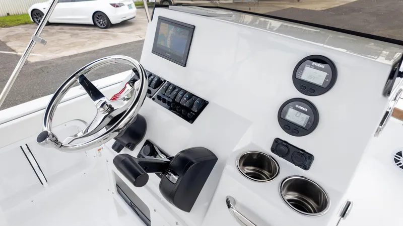 Slide: The Image of 2025 Stingray 173CC boat dashboard with steering wheel, controls, and digital displays. - 16