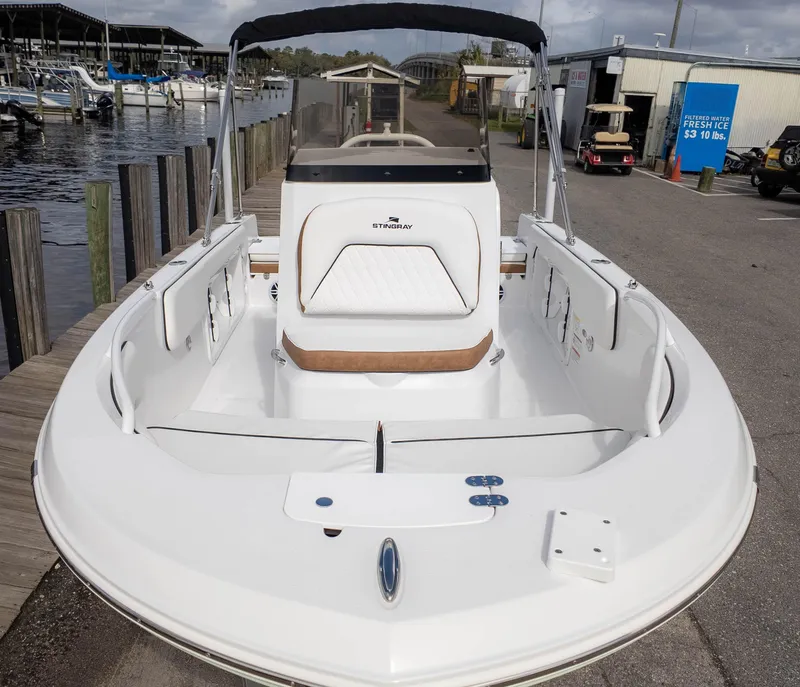 Slide: The Image of 2025 Stingray 173CC boat docked at marina, showcasing sleek design and spacious seating. - 3
