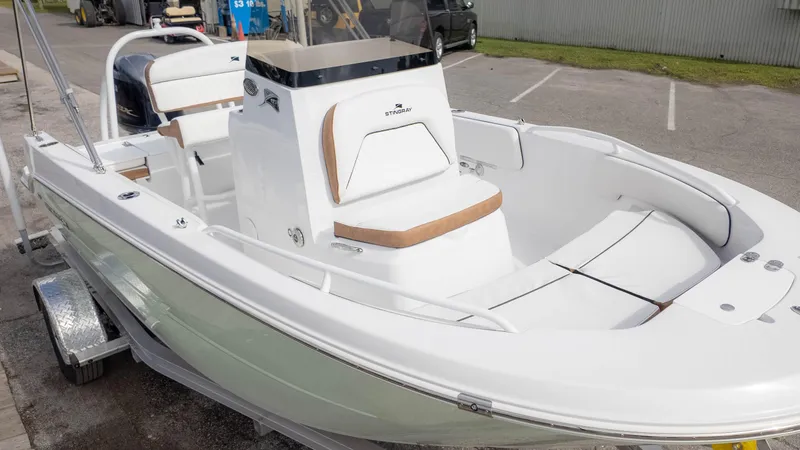 Slide: The Image of 2025 Stingray 173CC boat on trailer, featuring sleek white design and spacious seating. - 4