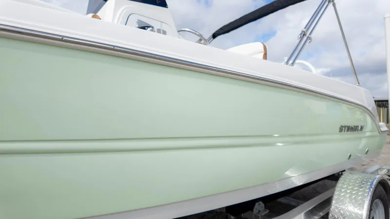 Slide: The Image of 2025 Stingray 173CC boat with sleek design and light green hull. - 6