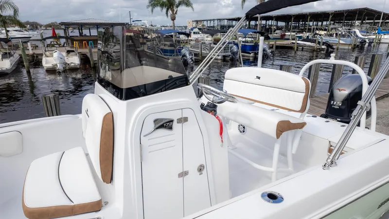 Slide: The Image of 2025 Stingray 173CC boat docked at marina, featuring sleek design and comfortable seating. - 7