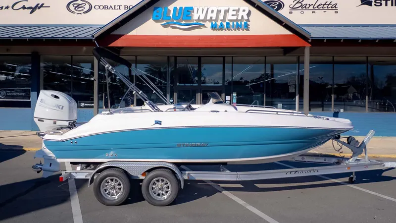Slide: The Image of 2025 Stingray 192SC boat on trailer at Bluewater Marine dealership. - 1