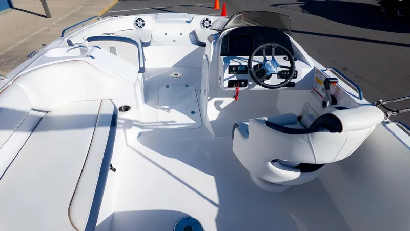 Slide: The Image of 2025 Stingray 192SC boat interior with white seating and modern dashboard. - 11