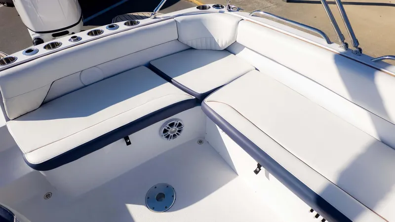 Slide: The Image of 2025 Stingray 192SC boat interior with white cushioned seating and cup holders. - 12