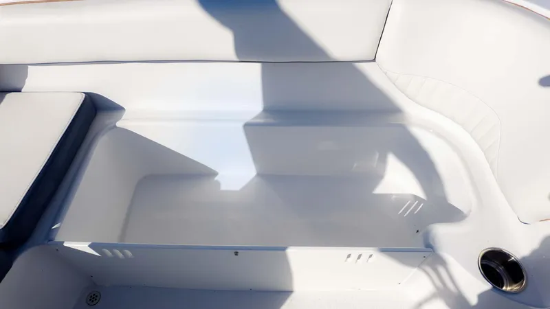 Slide: The Image of Interior seating area of 2025 Stingray 192SC boat, featuring white upholstery and cup holder. - 14