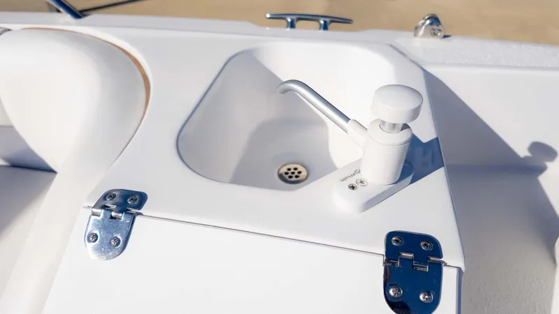 Slide: The Image of 2025 Stingray 192SC boat sink with faucet and stainless steel hinges. - 17
