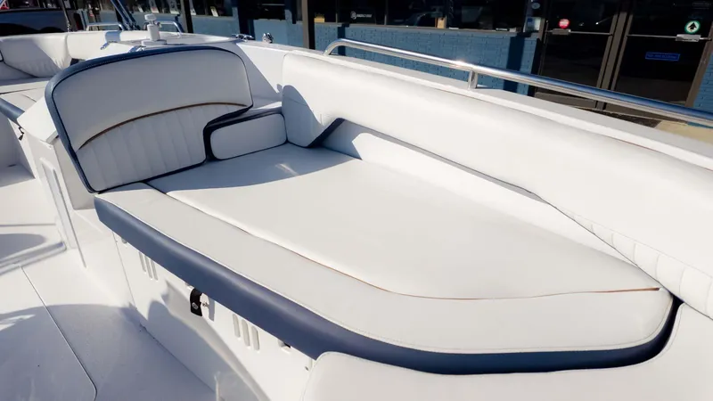 Slide: The Image of 2025 Stingray 192SC boat interior with white cushioned seating and blue accents. - 18