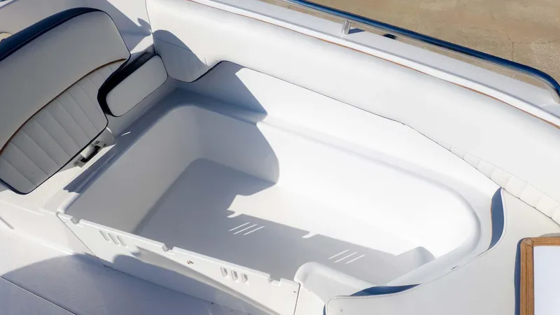 Slide: The Image of 2025 Stingray 192SC boat interior with white seating and storage compartment. - 19