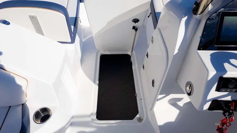 Slide: The Image of 2025 Stingray 192SC boat interior with open storage compartment and seating area. - 22