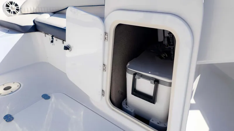 Slide: The Image of 2025 Stingray 192SC boat storage compartment with cooler inside. - 23