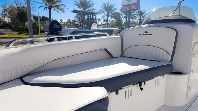 Slide: The Image of 2025 Stingray 192SC boat interior with white seating and sunny outdoor setting. - 24