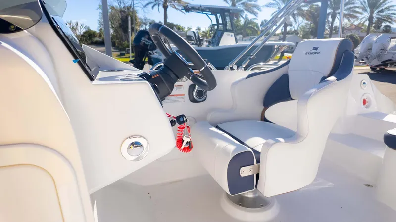 Slide: The Image of 2025 Stingray 192SC boat interior with steering wheel and comfortable seating. - 25
