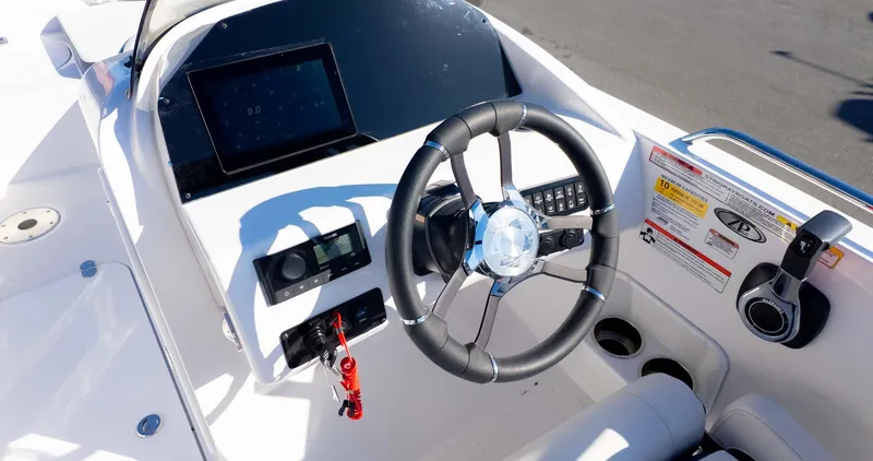 Slide: The Image of 2025 Stingray 192SC boat dashboard with steering wheel and control panel. - 26