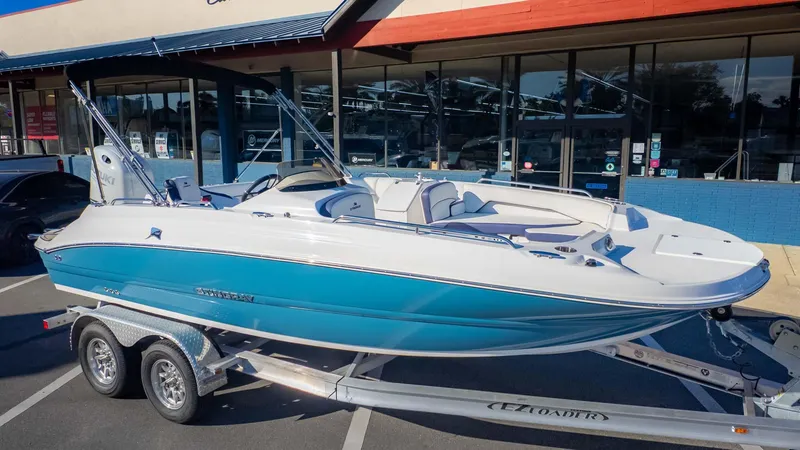 Slide: The Image of 2025 Stingray 192SC boat on trailer, parked outside a store. - 3