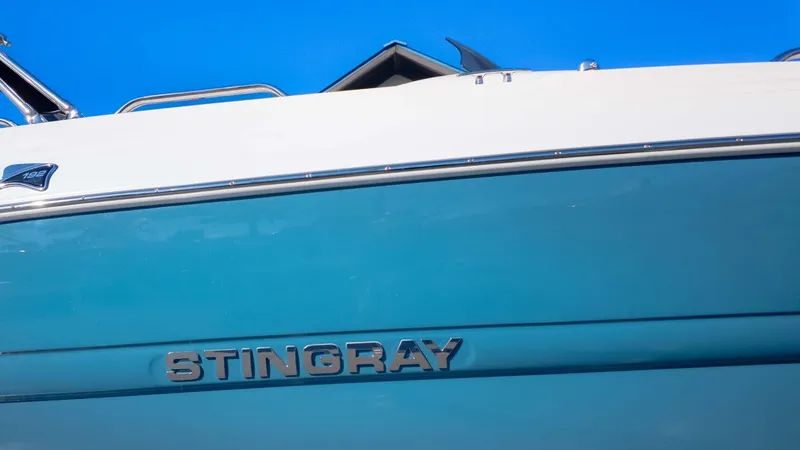 Slide: The Image of 2025 Stingray 192SC boat with blue and white exterior against clear sky. - 4