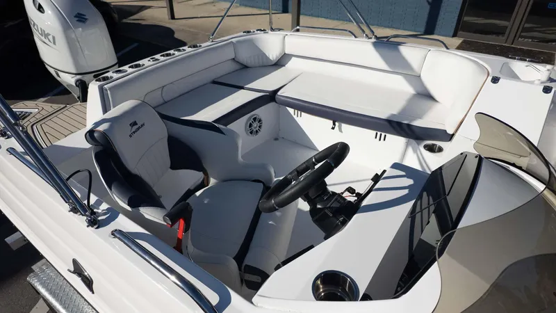 Slide: The Image of 2025 Stingray 192SC boat interior with steering wheel, seating, and Suzuki engine. - 8