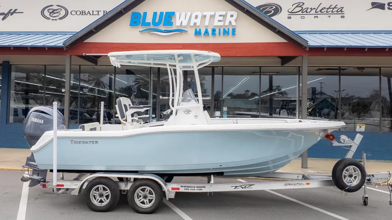 Slide: The Image of 2025 Tidewater 210CC boat on trailer at Bluewater Marine dealership. - 1