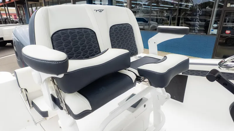 Slide: The Image of 2025 Tidewater 210CC boat seat with black and white upholstery, featuring armrests and modern design. - 14