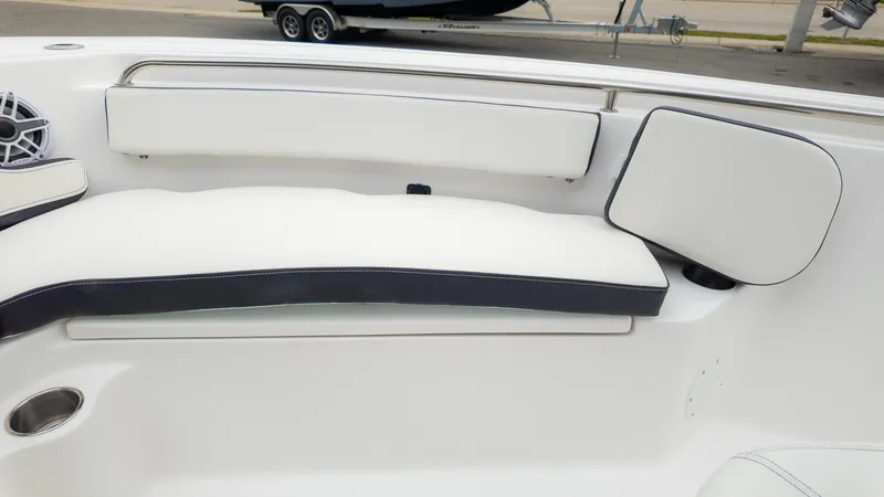 Slide: The Image of 2025 Tidewater 210CC boat interior with white cushioned seating and speaker. - 15