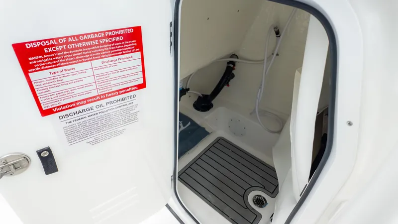 Slide: The Image of Interior of 2025 Tidewater 210CC boat showing waste disposal instructions. - 17