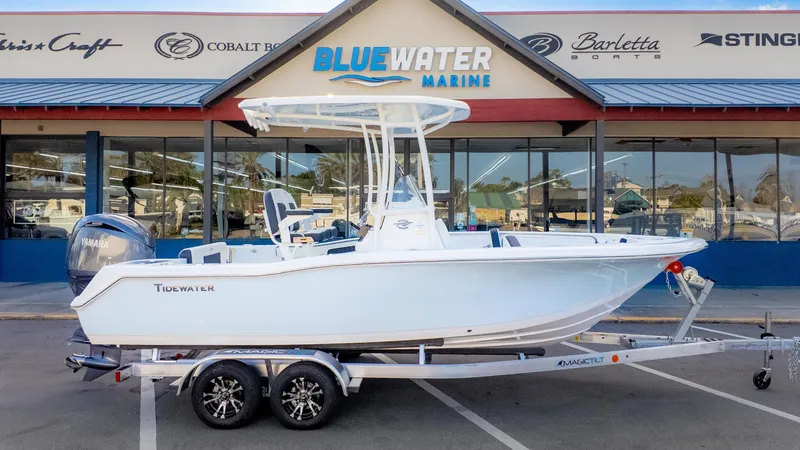 Slide: The Image of 2025 Tidewater 210CC boat on trailer at Bluewater Marine dealership. - 1