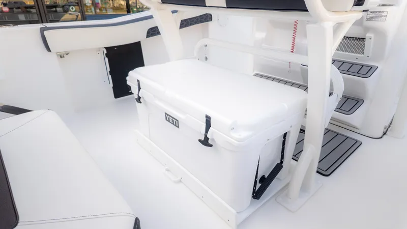 Slide: The Image of 2025 Tidewater 210CC boat interior with Yeti cooler and seating area. - 13