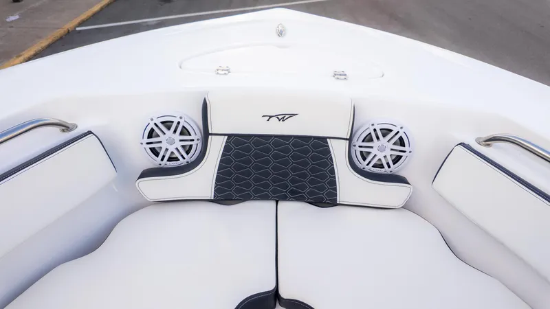 Slide: The Image of 2025 Tidewater 210CC boat interior with cushioned seating and speakers. - 18