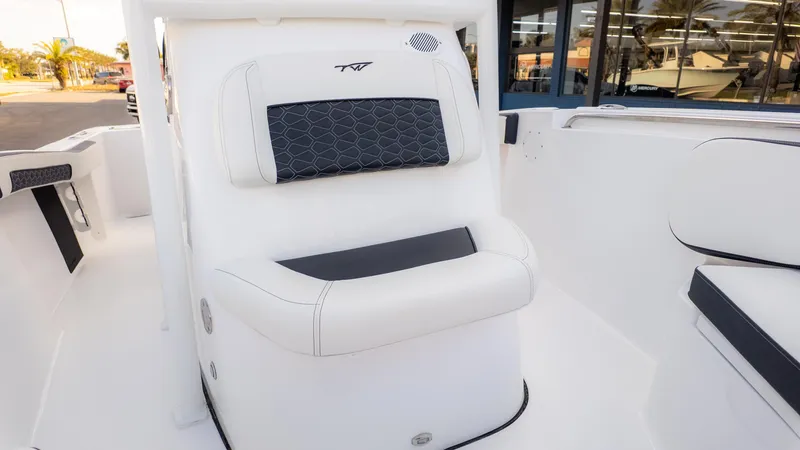 Slide: The Image of 2025 Tidewater 210CC boat interior with white and black cushioned seating. - 19
