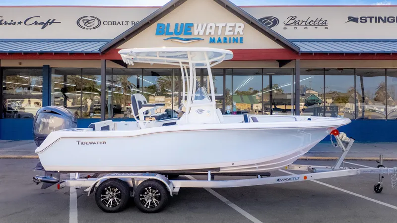 Slide: The Image of 2025 Tidewater 210CC boat on trailer at Bluewater Marine dealership. - 2