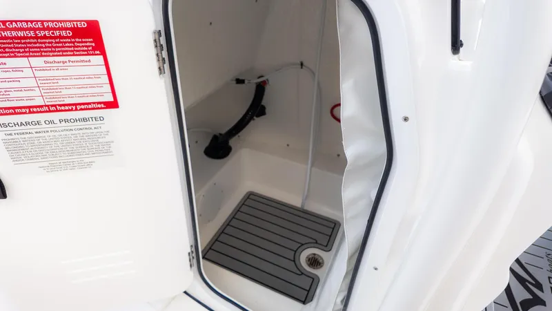 Slide: The Image of Interior view of 2025 Tidewater 210CC boat compartment with safety notices. - 20