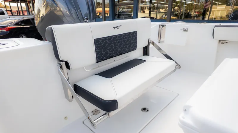 Slide: The Image of 2025 Tidewater 210CC boat interior with foldable white and black seating. - 21