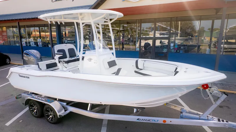 Slide: The Image of 2025 Tidewater 210CC boat on trailer outside dealership. - 3
