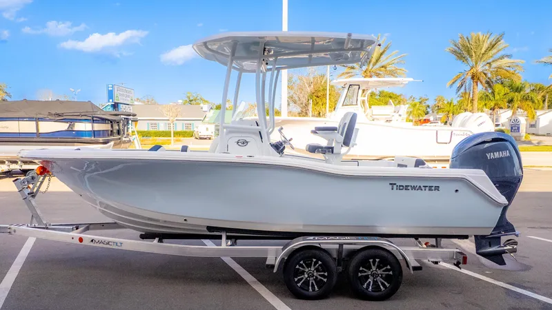 Slide: The Image of 2025 Tidewater 210CC boat on trailer, featuring Yamaha engine, parked outdoors. - 4