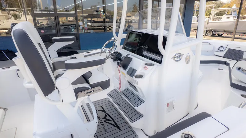 Slide: The Image of 2025 Tidewater 210CC boat interior with modern helm and seating. - 6
