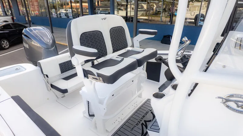 Slide: The Image of 2025 Tidewater 210CC boat interior with dual seating and Yamaha engine. - 8