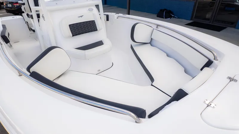 Slide: The Image of 2025 Tidewater 210CC boat interior with white and black cushioned seating. - 9
