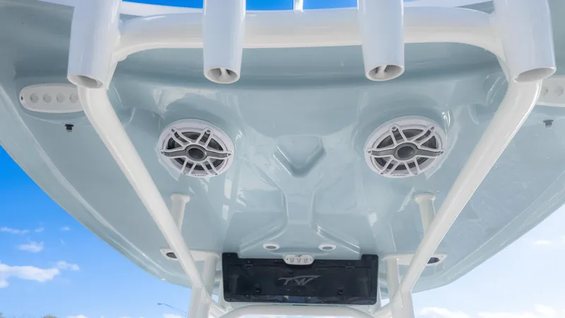 Slide: The Image of 2025 Tidewater 220cc boat speakers and rod holders against a clear blue sky. - 12